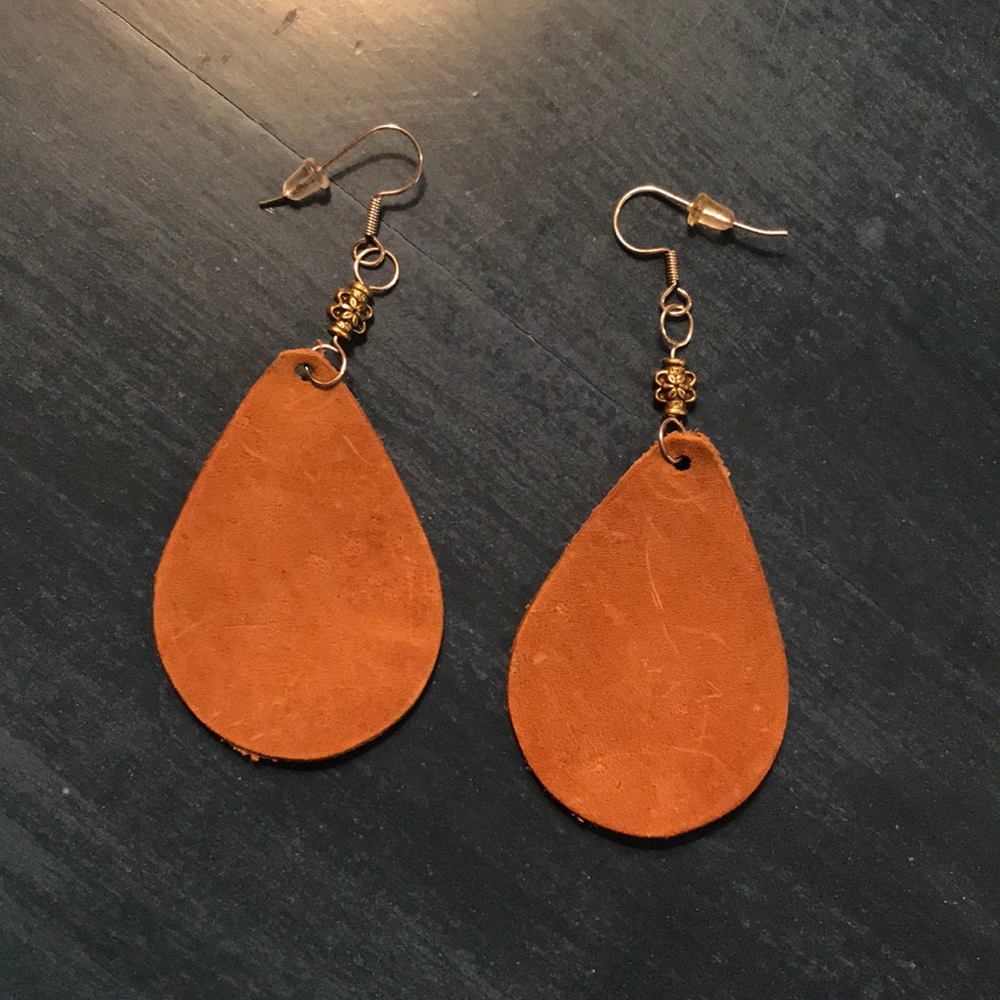 Hand tooled leather earrings.  Tan